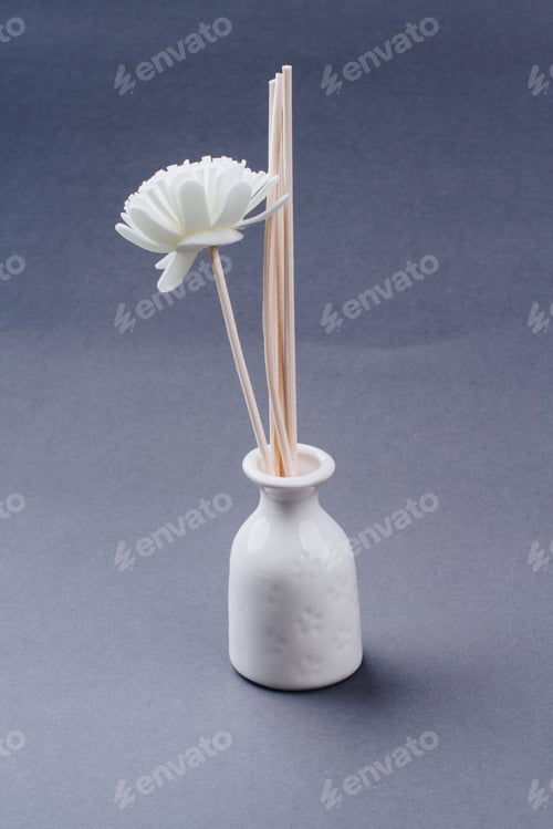 Preview: Spa flower in a white vase on grey background.