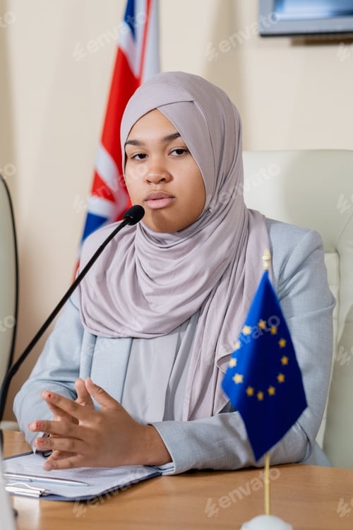 Preview: Young successful female politician in hijab making report