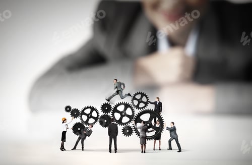 Preview: Businesswoman Looking At Team Of Businesspeople In Miniature
