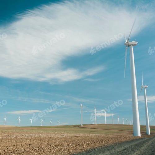 Preview: Wind turbines, tall white towers in the flat plains by a road near the Columbia River Gorge.
