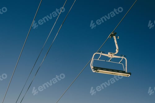 Preview: Elevated passenger ropeway on a sunny day with a blue sky in the background