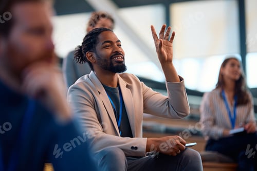 Preview: Happy black business seminar attendee asking a question from the audience.