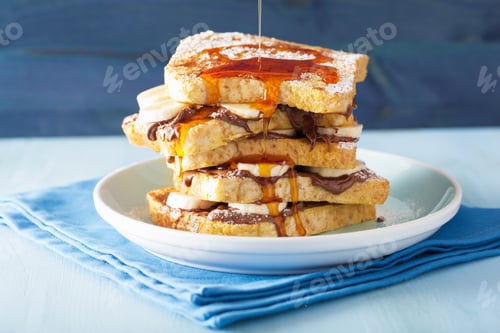 Preview: pouring caramel over french toasts with banana chocolate sauce f
