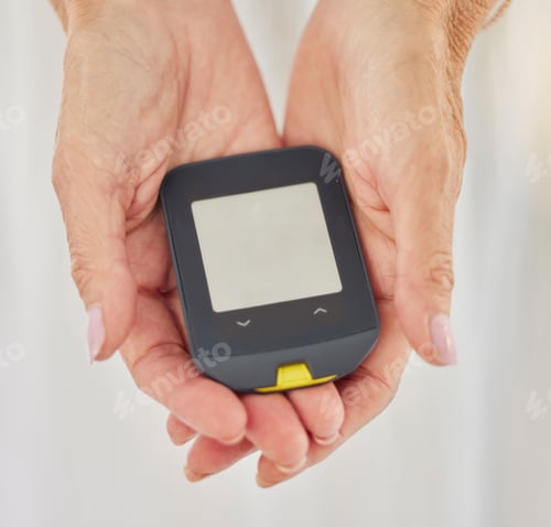 Preview: Closeup of a senior diabetic woman checking her blood sugar glucose levels with a diabetes reading