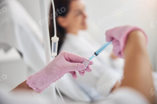 Preview: Female in sterile gloves performing a medical procedure