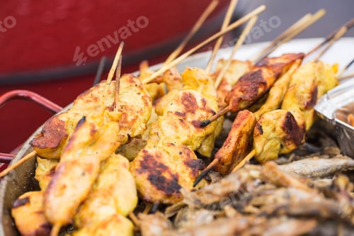 Preview: Street Food and meal concept. Grilled chickens inserted on wooden skewers was putting on street shop