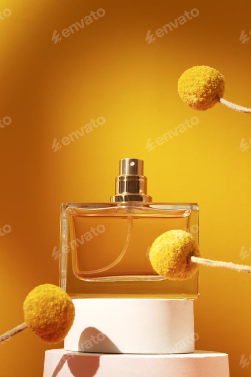 Preview: Perfume bottle with craspedia flowers.