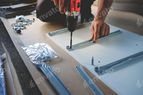 Preview: Assembling Furniture at Home. DIY Concept. Craftsman using Cordless Screwdriver