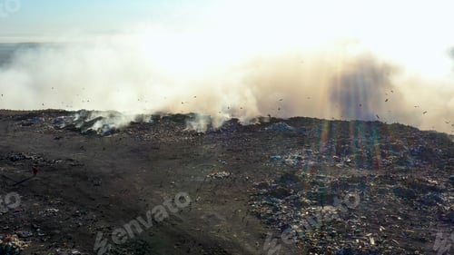 Preview: Aerial view of burning garbage piles in trash landfill