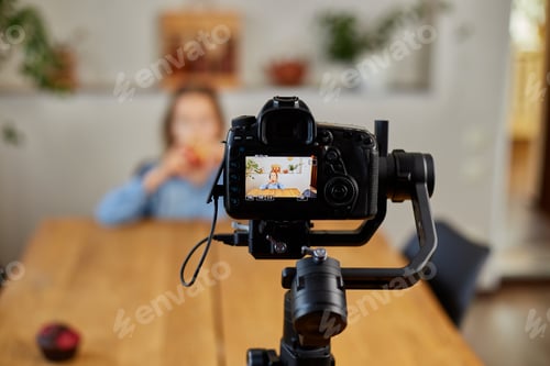 Preview: Beautiful young girl filming her blog broadcast about healthy food
