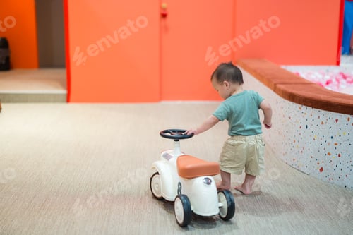 Preview: Little baby playing with toy car at play house