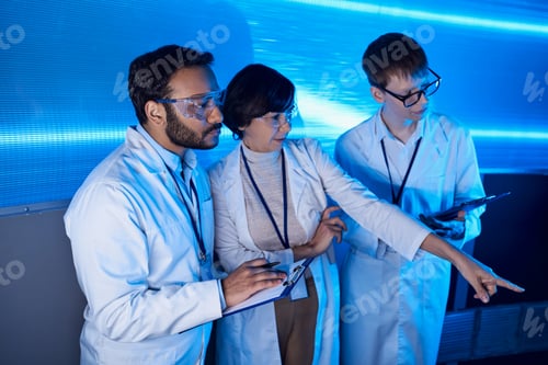 Preview: futuristic science center, woman scientist pointing with finger near multiethnic colleagues