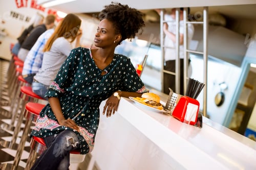 Preview: Young african american woman in the diner