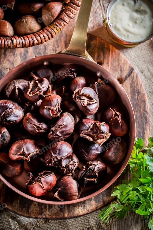 Preview: Fresh chestnuts with parsley on old wooden table