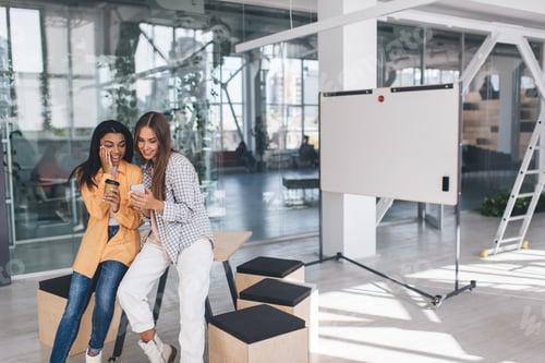 Preview: Women using mobile phone and drinking coffee