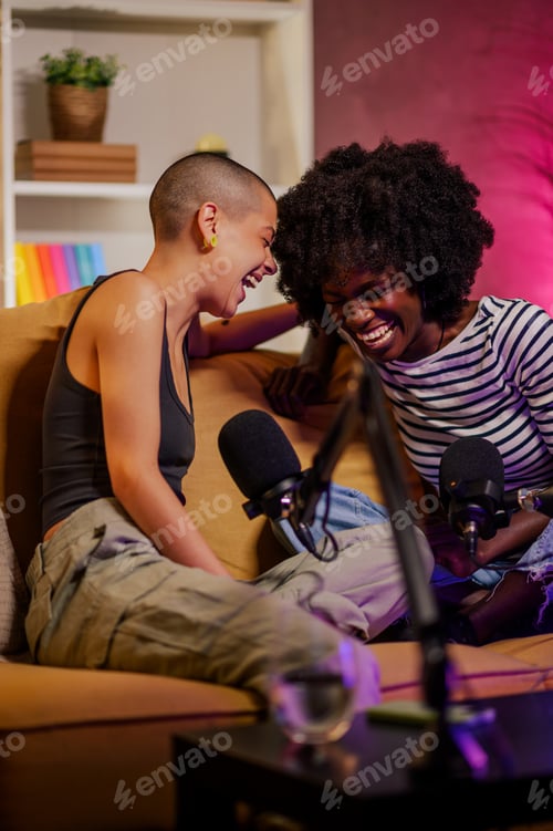 Preview: Diverse women recording episode of internet podcast in a modern studio and laughing