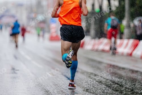 Preview: rear view runner athlete run marathon race on rain