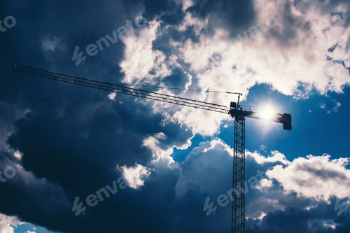 Preview: Silhouette of industrial construction crane with dramatic sky background. Details of industry