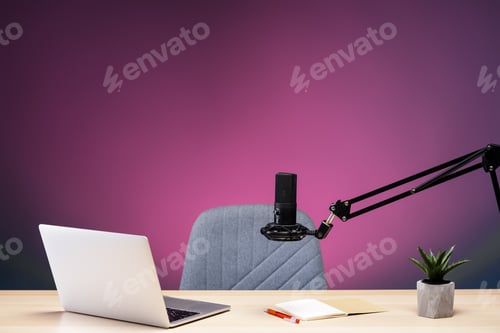 Preview: Professional microphone, laptop, and notebook on a desk preparing for recording