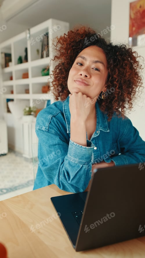 Preview: Thoughtful Woman At Home Working With Laptop