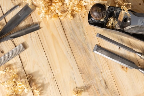 Preview: Top view of a traditional carpenter tools and wood shavings lying on wooden planks. Copy space