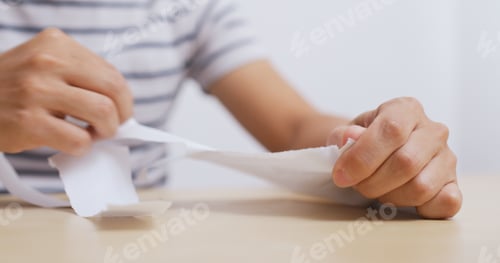 Preview: Man tearing the letter at home