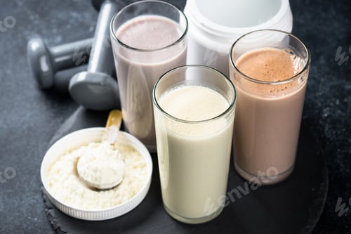 Preview: Protein cocktails and dumbbells, sport and fitness concept.