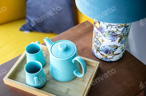 Preview: Teapot and two blue cups on the table, top view.