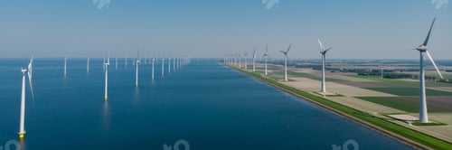 Preview: Windmill turbines at sea seen from a drone aerial view from above at a huge winmill park