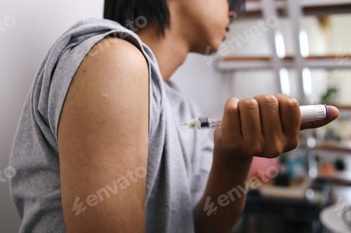 Preview: Close Up Of Shoulder While Holding Injection.