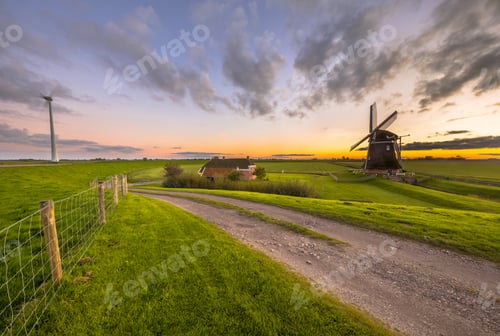 Preview: Historic windmill in grassy dairy landscape