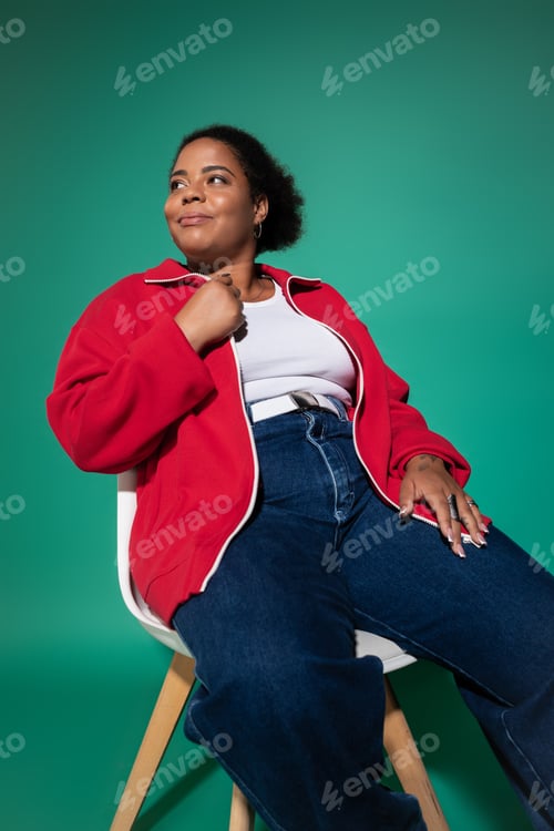 Preview: Chic plus-size African American woman displays trendy autumn fashion in studio