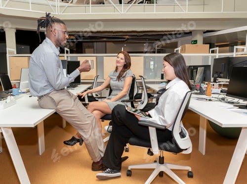 Preview: group of three relaxed multiracial entrepreneurs taking a break from work