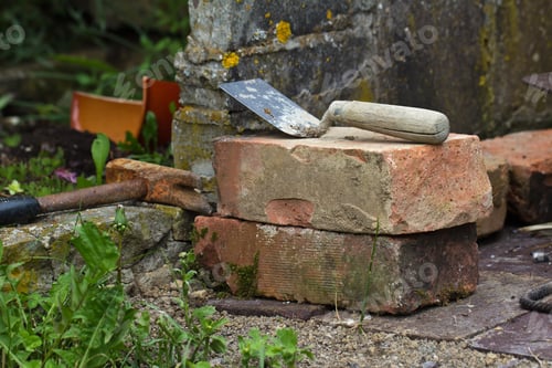 Preview: Closeup shot of brown bricks with tools for the construction
