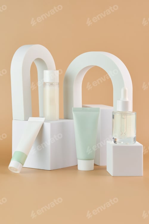 Preview: Cosmetics packaging. Set of different cosmetic jars and tubes of cream on white podiums. Blank pack
