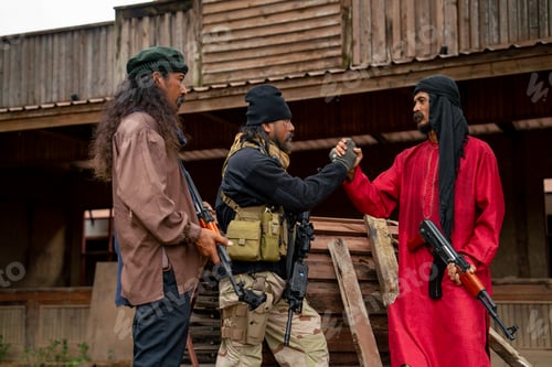 Preview: Group of men with soldier and arab clothes stand with holding hand look like join to fight the enemy