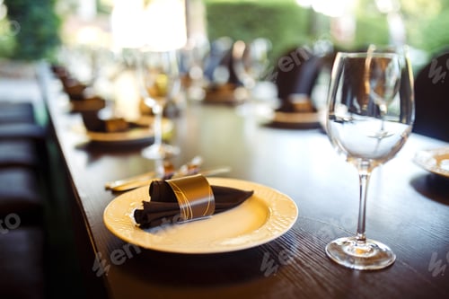 Preview: Sparkling glassware stands on long table prepared for wedding dinner.