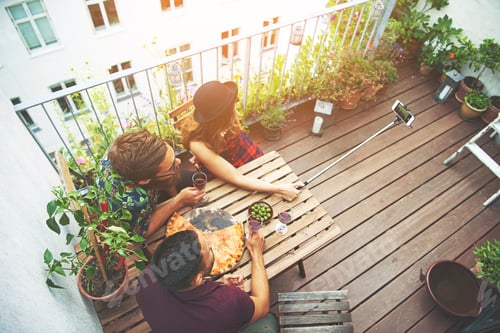Preview: Overhead view of friends on patio taking photo