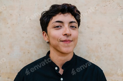 Preview: Close up view of a young transgender man looking at camera.