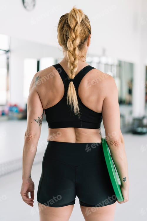 Preview: back view Woman exercising with disc