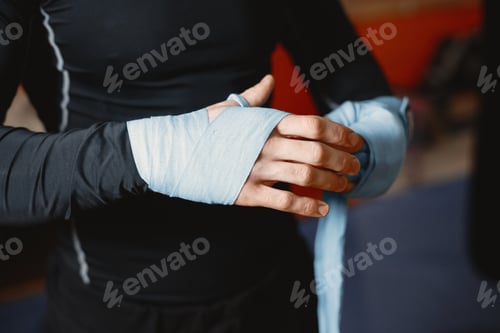 Preview: Male boxer in black gloves at the gym
