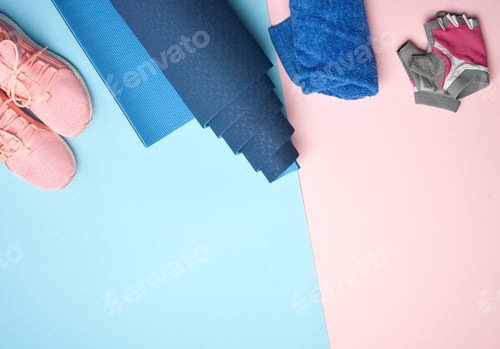 Preview: Rolled up sports mat, pink sneakers, towel and gloves for sports, top view