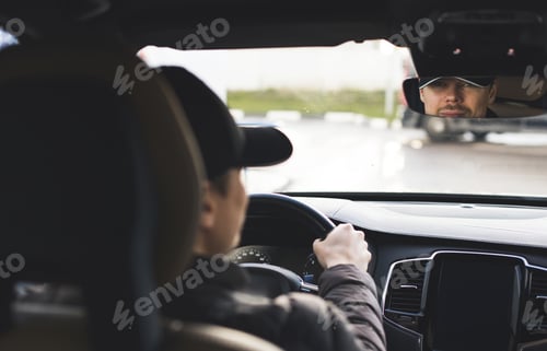 Preview: Man os smiling driving a luxury premium car, holding steering wheel