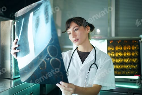 Preview: Portrait of young doctor checking X-Ray in hospital to make diagnosis