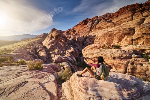 Preview: african american woman at red rock canyon taking selfie on ledge