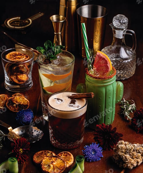 Preview: Vertical closeup shot of delicious exotic colorful cocktails surrounded by garnish
