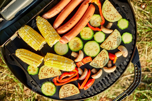 Preview: Roasting vegetables and vegan sausages on the barbecue gas grill outdoor in the backyard