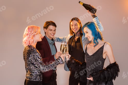Preview: tattooed nonbinary person holding champagne bottle near queer friends clinking glasses on grey