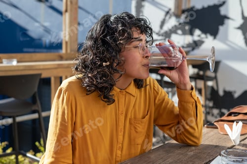 Preview: Woman seen drinking red wine outdoors