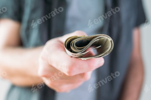 Preview: Man holding Serbian currency Dinar paper banknotes